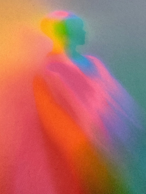 Close detail of What Comes Back by Atelier Kalle Hellzén, hand-signed and numbered Limited Edition of 5. The upper figure seen near full bleed, colour shifting from orange and pink to green and blue across the body, the paper fibre legible through the pigment. Giclée on handmade kozo washi.