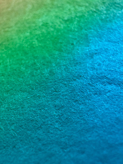Surface detail of What Comes Back by Atelier Kalle Hellzén, the pigment reading as bands of orange, pink and teal across the visible fibre of the handmade sheet, with no figure in frame. Giclée on handmade kozo washi.