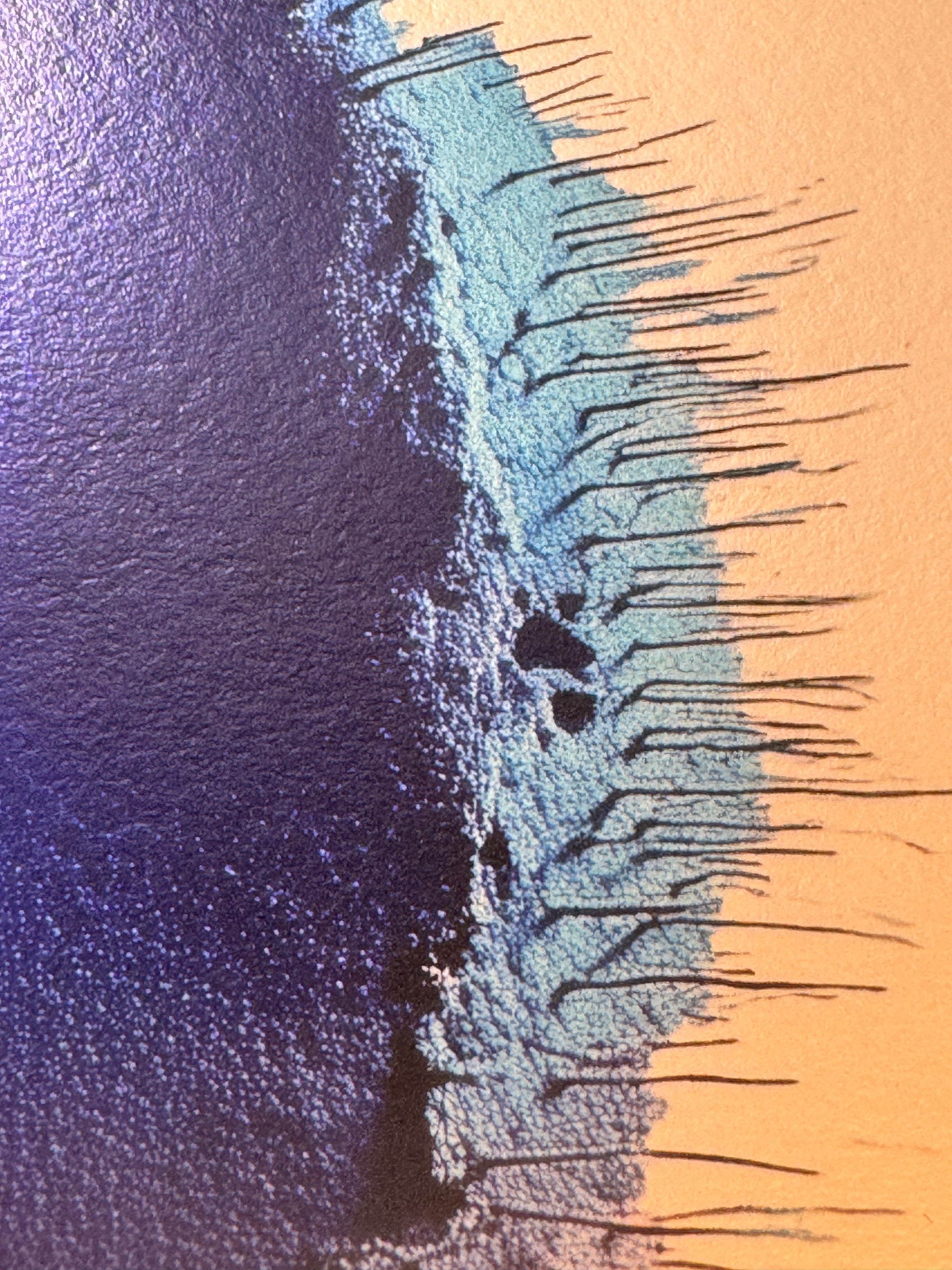 IMPACT 0016, close crop of the ragged edge where deep indigo blue meets a pale turquoise band, both fraying into thin blue-black threads against warm gold paper.