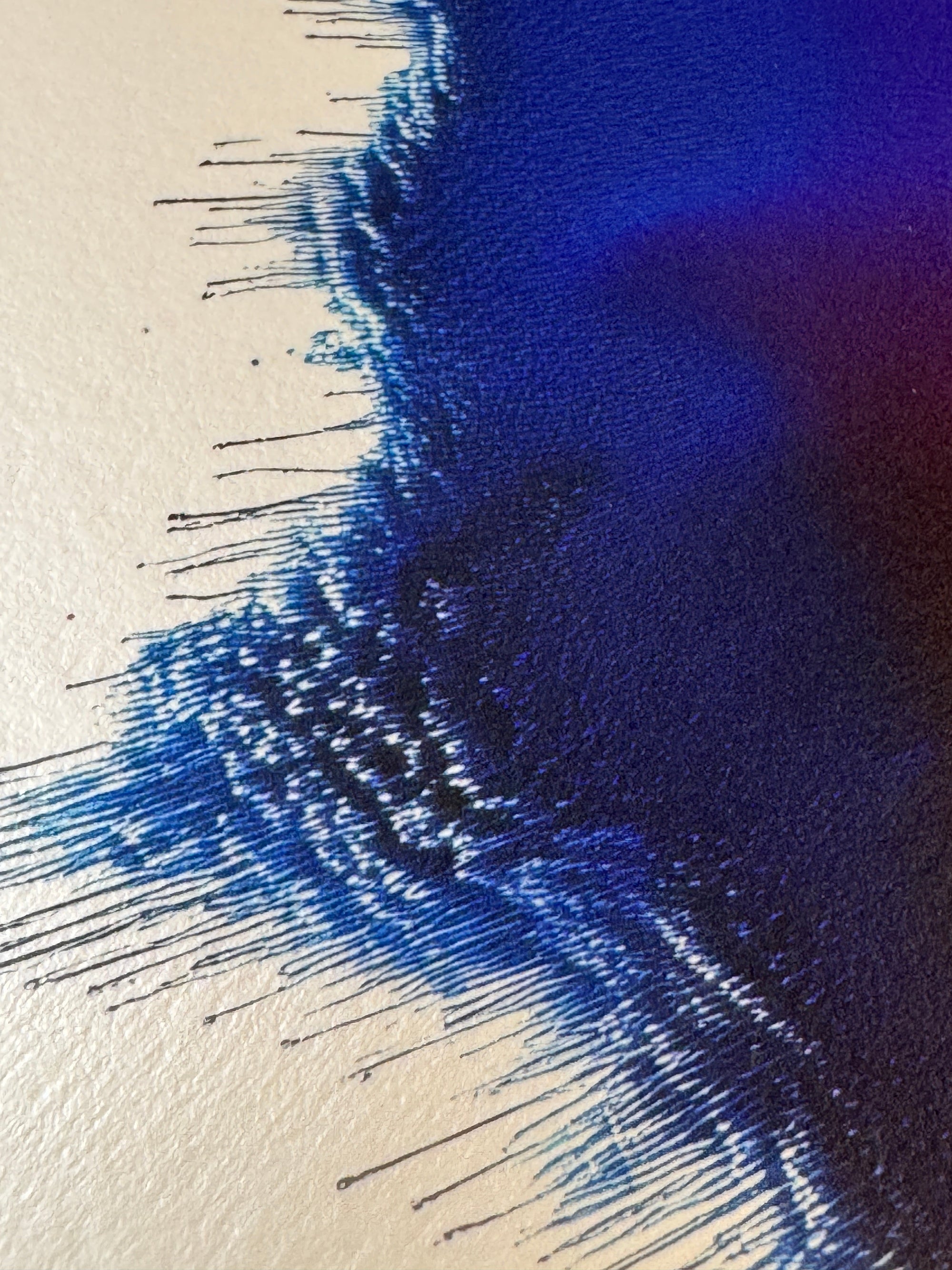 IMPACT 0018, close crop of the ragged edge showing dark navy-black fringe with fine dripping threads, against a strip of cream paper visible at the upper corner.