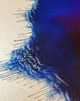 IMPACT 0018, close crop of the ragged edge showing dark navy-black fringe with fine dripping threads, against a strip of cream paper visible at the upper corner.