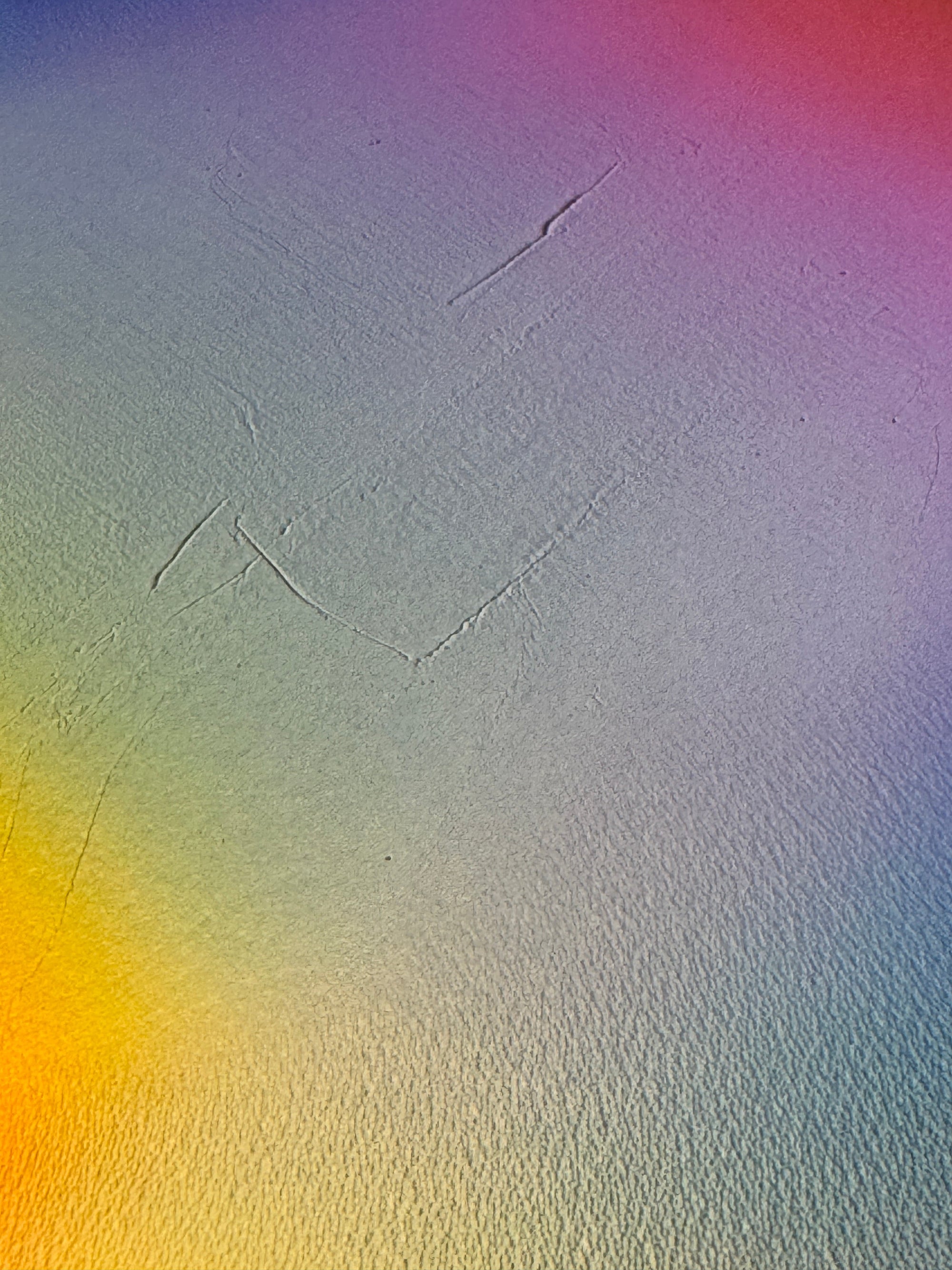 IMPACT 0018, close-up of the blank cream paper beside the disc, showing its fine texture under a soft blue, purple, pink, yellow, and green colour wash, with a couple of faint diagonal scratch lines.