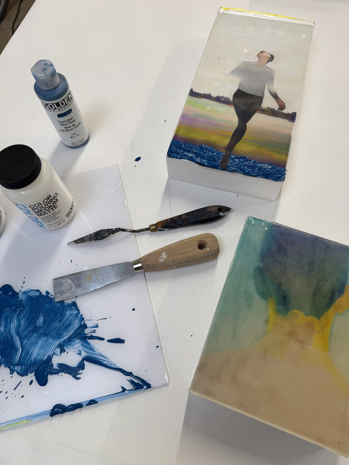 Fragments in the atelier: boards in progress, cerulean blue on the palette