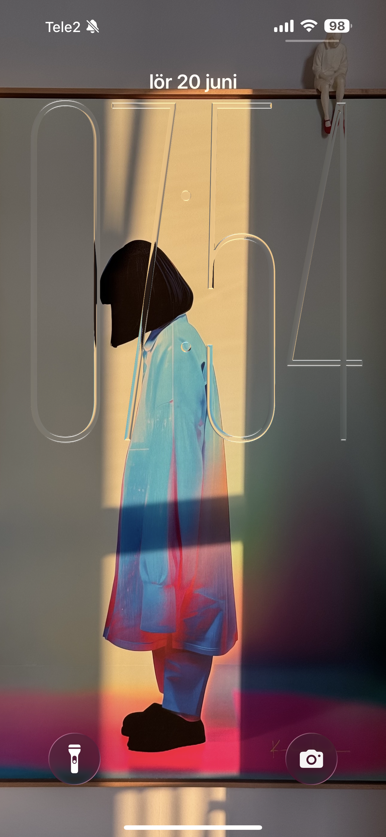 Home (2024 timed edition) by Kalle Hellzén shown as an iPhone lock screen