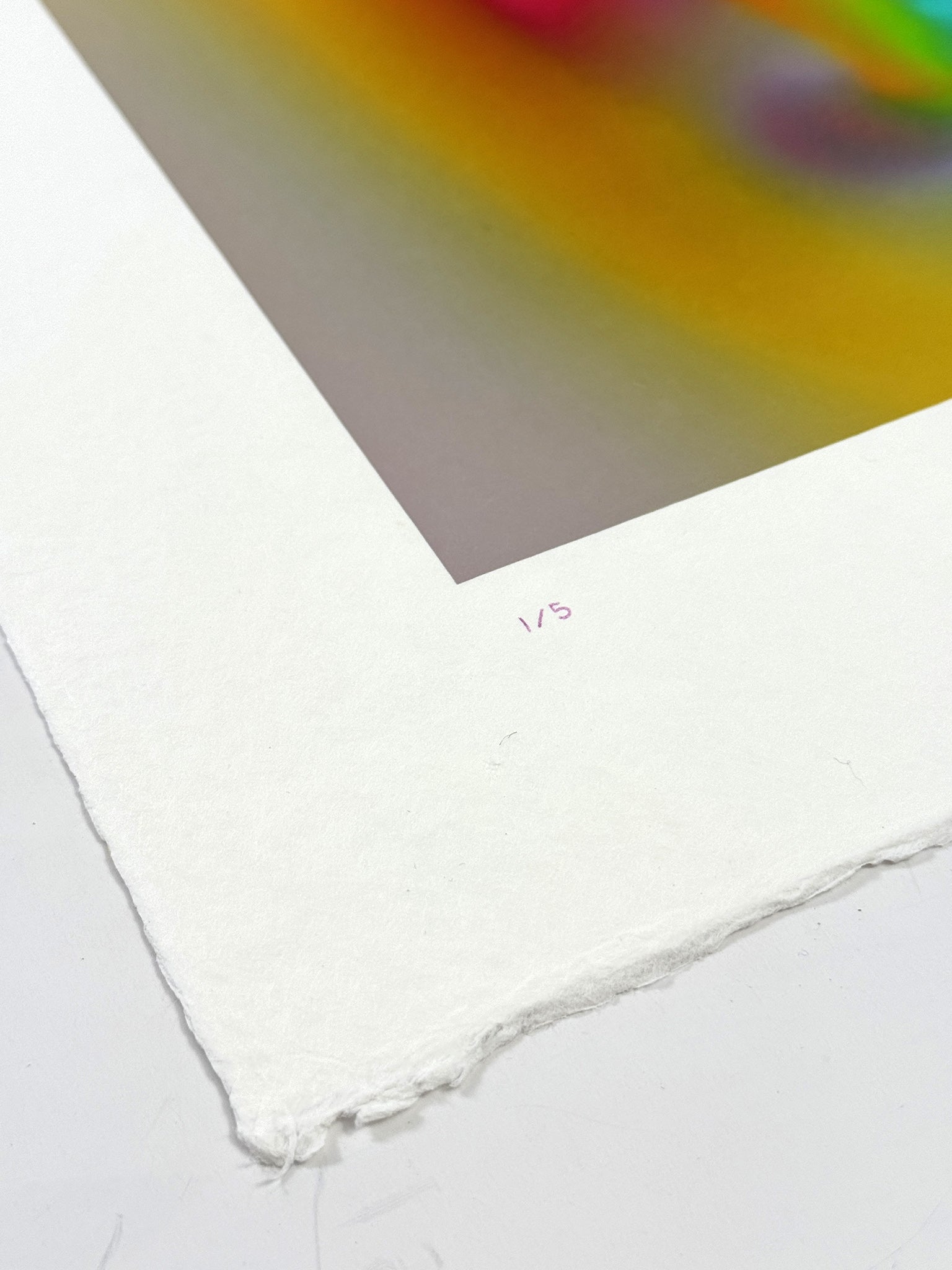 Detail of What Comes Back by Atelier Kalle Hellzén showing the hand-written edition number "1/5" on the lower deckle edge, beneath a corner of the print's orange-and-magenta field. Hand-signed and numbered Limited Edition of 5 on handmade kozo washi.