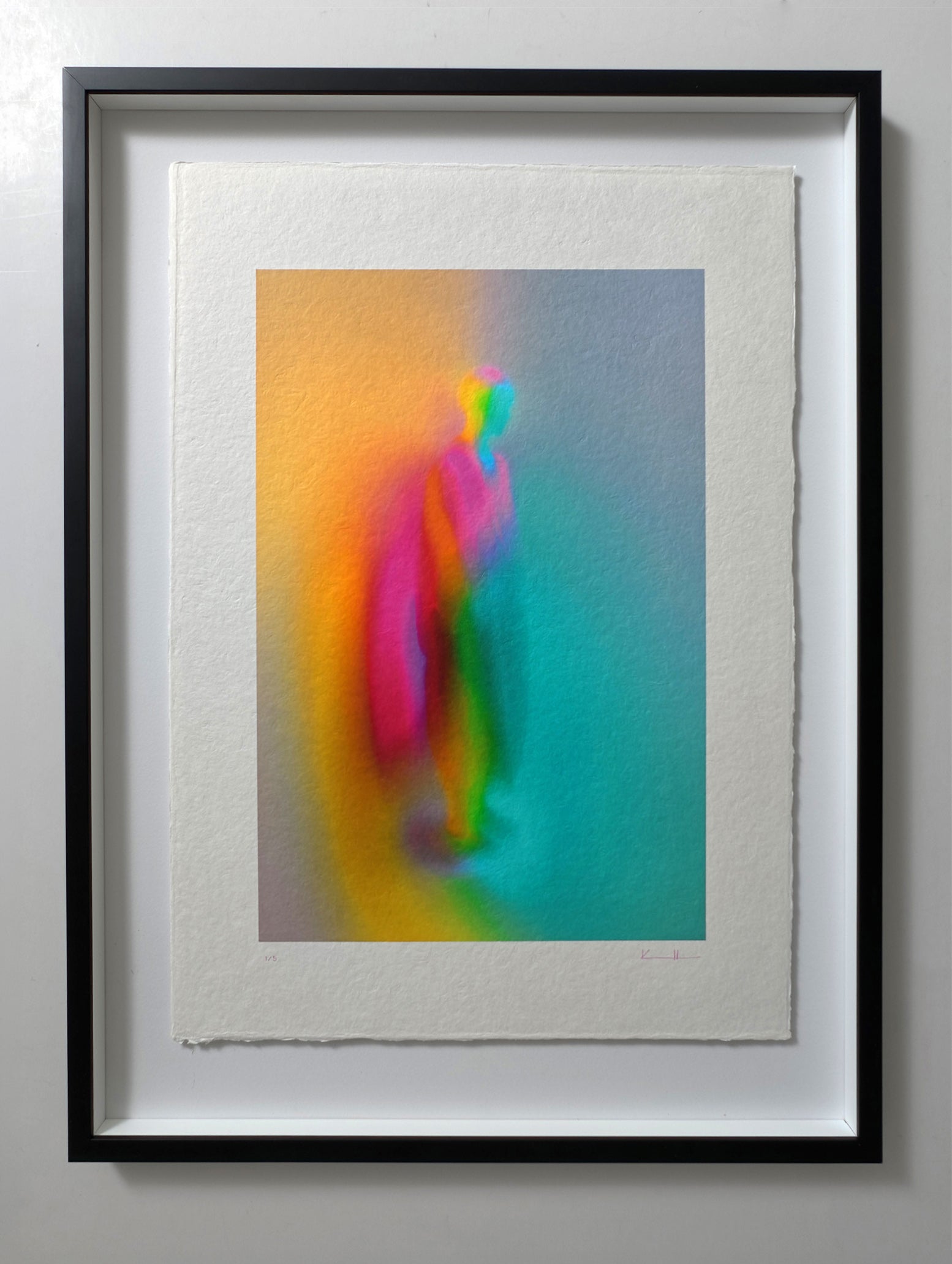 What Comes Back by Atelier Kalle Hellzén, hand-signed and numbered Limited Edition of 5, shown in a black frame on a pale wall. The deckle-edged sheet floats inside the mount, the saturated figure held against the dark surround. Giclée on handmade kozo washi.